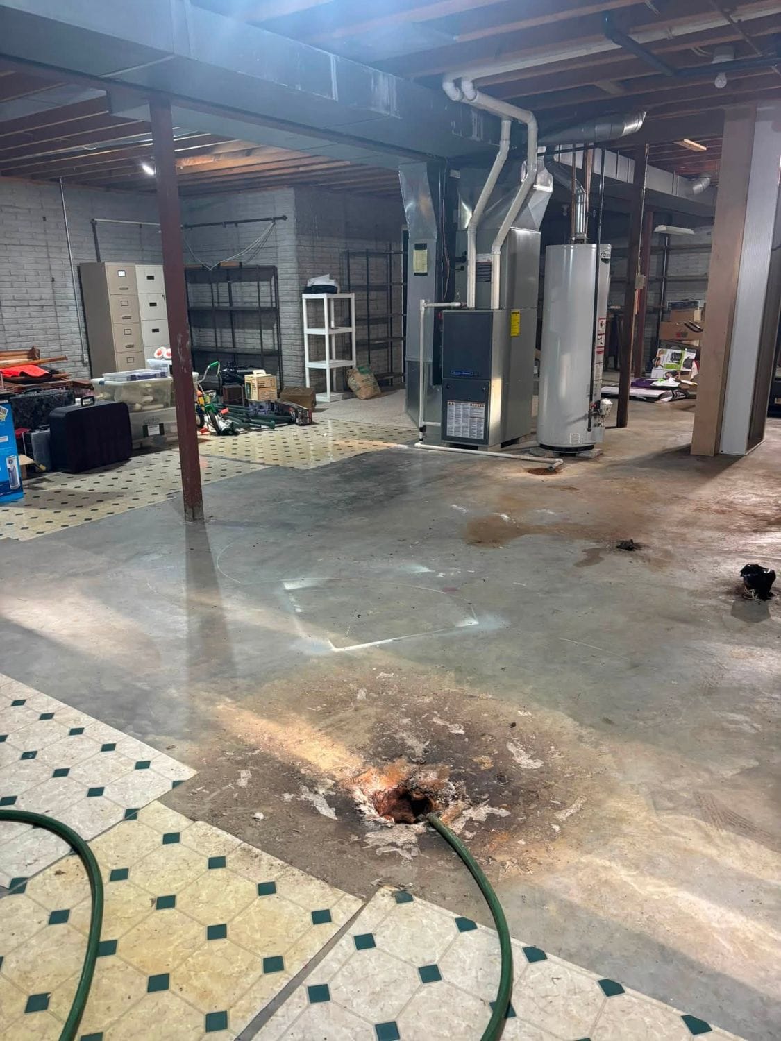 The same basement with the floor cleared around the furnace and water heater