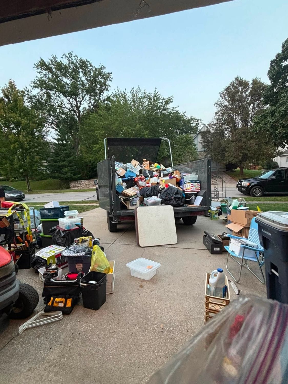Trailer loaded with household items in a driveway